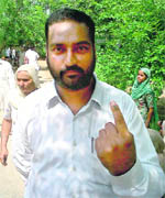 Balkaran Singh (with shorn hair) of Kauni village in the Dodha segment shows the black ink mark after casting his vote on Sunday. 