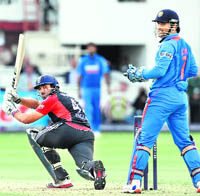 Englands Ravi Bopara hits a boundary against India as MS Dhoni looks on. India lost the ODI series 3-0.