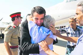 BACK TO MOTHERLAND: One of the two Libyan pilots who defected to Malta embraces a well-wisher upon his return to Tripoli on Sunday