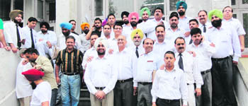 Members of the Amritsar Bar Association observe a strike outside the judicial complex on Monday. 