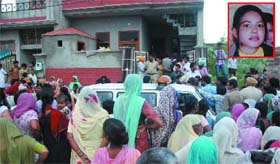 People gathered outside the house of Rani (inset), who was found murdered, in Baba Deep Nagar in Bathinda on Monday