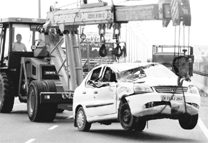 A JCB machine tows away the car that met with an accident at Zirakpur on Monday.