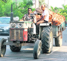A tractor-trailer loaded with bricks plies illegally near Namdev Chowk in Jalandhar on Monday.