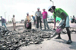 Workers carry out repairs on the old Tawi bridge in Jammu