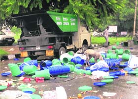 Garbage bins lying strewn on a road in Sarabha Nagar, Ludhiana, as a mark of protest against the door-to-door solid waste collection