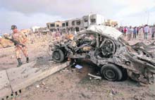 A soldier walks past the site of the suicide bomb attack in Karachi on Monday. 
