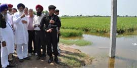 Chief Minister Parkash Singh Badal visits a water-logged field in Muktsar on Tuesday.