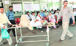 Khan Mohammad (65) of Yamunanagar being taken back to his town as senior doctors (in background) went on strike at GMCH-32, Chandigarh