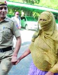 The police produces before the media a woman accused of human trafficking at the PHQ in New Delhi on Tuesday. 