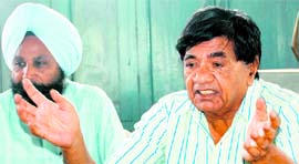 Dr Joginder Dayal addresses a news conference in Amritsar.