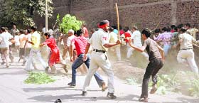Protesting migrant labourers being chased away by cops in Jalandhar on Tuesday