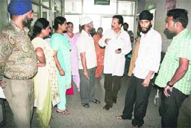 Relatives and neighbours of Savitri talk to the authorities at the Gandhi Nagar Government Hospital in Jammu on Tuesday