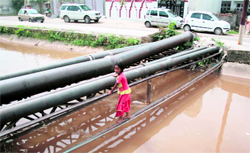 Unaware of the risk involved, a girl tries to cross a water channel at Trikuta Nagar in Jammu