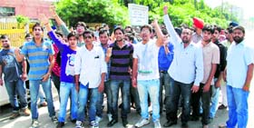 Students raise slogans against the college authorities, which do not allow them to park their vehicles on the premises of the institute in Ludhiana on Tuesday.