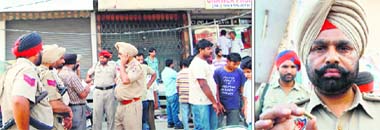 A police party outside the jewellery shop on Majitha Road where the robbery took place on Wednesday. (Right) A policeman shows the empty bullet shell recovered from the scene of crime