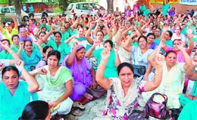 Members of the Auxiliary Nursing Midwives (ANM) and Lady Health Visitor (LHV) union hold a dharna in Amritsar on Wednesday