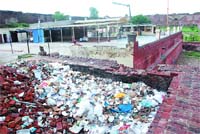 Heaps of garbage have been dumped adjacent to the Gurdwara Quila Mubarak in Bathinda creating problems for the visitors.