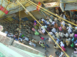 Securitymen and the public gather at Sitaram Bazar in the Turkman Gate area after a clash between two groups in New delhi on Wednesday.