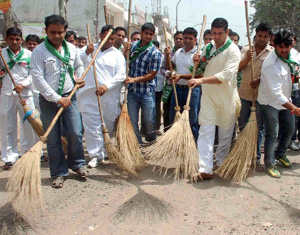 INLD workers sweep a road to register their protest in Faridabad on Wednesday. 