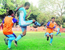 Players of RIMC ( in blue) and SGRR, Bindal (in orange) in action in a match in the Ram Bahadur Chhetri Memorial Football Tournament in Dehradun on Wednesday