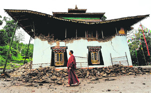 A Buddhist monk walks past the damaged Ringhim Monastery in Mangan. The recent quake reportedly caused Rs 3,400-crore damage in the Darjeeling Hills. 