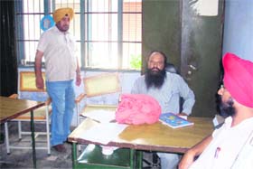 Kanungo Dildar Singh sitting without turban at the patwarkhana in Phagwara on Wednesday