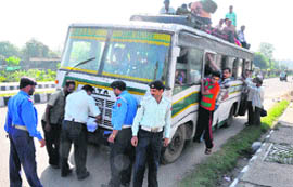 Traffic cops challan an SRTC bus driver for overloading in Jammu