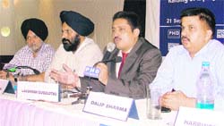 Lakshaman Gugulothu, CEO, BSE SME Exchange, addresses a seminar in Ludhiana on Wednesday.