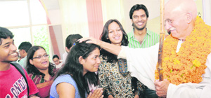 American Gandhi Bernie Meyer blesses a student at GGDSD College in Chandigarh on Thursday. 