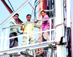 Three workers of MNREGA who climbed atop a mobile tower in Dehradun on Thursday