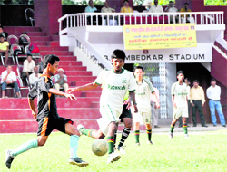 Players of Col Brown School ( in white) and Doon Valley School ( in black) vie for the ball in a match in the Ram Bahadaur Chhetri Memorial Football Tournament in Dehradun on Thursday