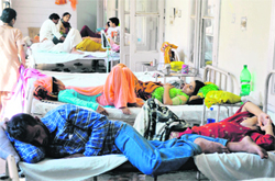 Patients share beds at the SMGS Hospital in Jammu