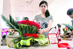 A girl participates in a flower arrangement competition organised by the Department of Students Welfare at University of Jammu on Thursday