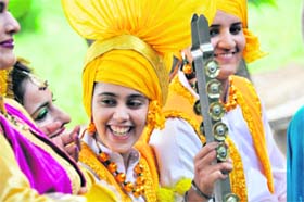 Students exchange light banter just before the start of a folk instrument competition during the Zonal Youth and Heritage Festival at Government College for Women in Ludhiana on Thursday