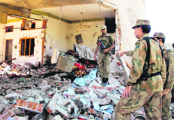 Pakistani soldiers at the house destroyed by an explosion in Mingora, the main town in the Swat Valley, on Thursday. Pakistani security forces killed three militants and arrested two others who were holed up with weapons in the house