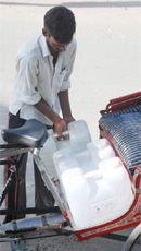A man takes away drinking water from an RO plant.