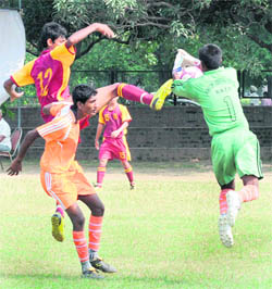 A player tries to beat the goalkeeper of the opposing team during the ongoing 9th Administrator's Challenge Cup Football Tournament for Boys (U-17) at Football Stadium, Sector 17, Chandigarh, on Friday.
