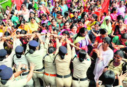 The police stops ASHA workers marching towards the residence of the Chief Minister in Dehradun on Friday
