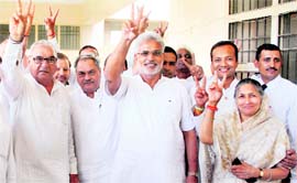 Chief Minister Bhupinder Singh Hooda and Jai Prakash (third from left) flash the victory sign after the latter filed his nomination papers as the Congress nominee for the Hisar Lok Sabha seat on Friday.