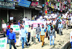 Traders hold a protest march in Manali on Friday