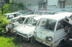 Vehicles under case property gather dust at the Dhobiana Basti in Bathinda. 