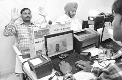 Voluntary or mandatory: People line up to register for their UID numbers for which digital images of the face, fingerprints and the iris are recorded