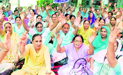 Members of the ANM and LHV Union on a dharna outisde the Civil Surgeon's office in Jalandhar on Saturday