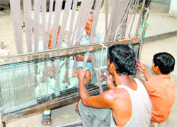 Weavers at a handloom factory in Amritsar. 
