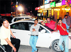 Youths relax outside a food joint at Sector 22 in Chandigarh at 2.25 am on Saturday