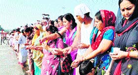 Women offer tarpan in the Ganga for those who killed during the 1947 Partition riots, in Haridwar on Sunday