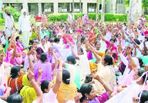 Activists of the Asha Workers Union stage a protest on the premises of the Civil Hospital in Ludhiana on Sunday.