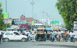 A policeman stops traffic near the Rajindra College as the Chief Ministers convoy was about to pass on Monday. The tight security created inconvenience for the commuters