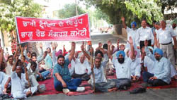 The residents of the city block the Bhagu road during a protest against the plying of heavy traffic on it in Bathinda 