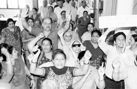 Residents stage a protest outside HUDAs office in Sector 6, Panchkula, on Monday. 
